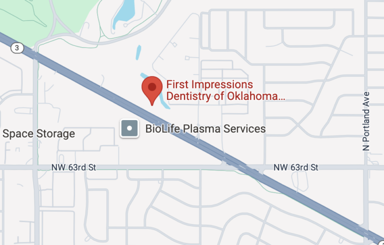 A map featuring the location of "First Impressions Dentistry of Oklahoma" marked with a red pin. Nearby landmarks include "BioLife Plasma Services" and "Space Storage," with major roads such as NW 63rd St and N Portland Ave highlighted.